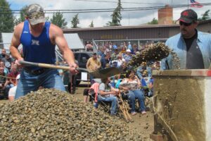 In the hand-mucking hardrock mining competition, miners race the clock to shovel a ton of muck into an antique ore car.