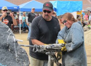 A hardrock mining drilling contest spectator enjoys the supervised opportunity to operate a jackleg drill.