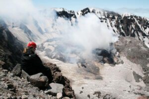 A USGS volcanologist observing volcanic activity on Mount St. Helens in 2007.