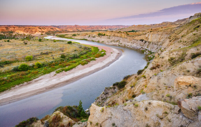Theodore Roosevelt National Park, Theodore Roosevelt National Park, shown here as landscape with a road running through it, is part of the history of U.S. presidents and geology.