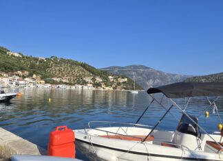 Ithaca, Greece: Monoliths and the Island of Odysseus The picturesque capital of Ithaca, Greece, and the main port of Vathy. In the background is the road leading high up to the Monoliths.