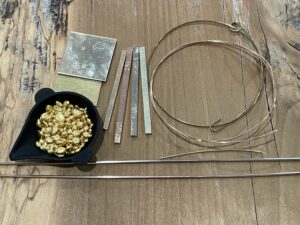 Gold in many forms, such as bar stock, sheet, wire and casting grain.