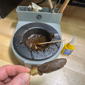 Cold wax dopped fossil walrus tooth ready for free-hand faceting.