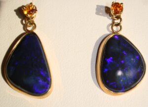 Black jelly opals with a purple flash fall within the midnight-blue gems palette