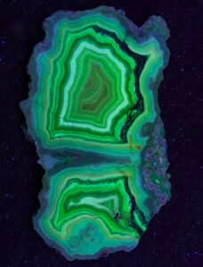 Laguna agate is a fluorescent agate that glows green under short-wave UV from uranyl ions as an activator.