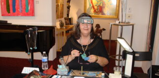 Helen Serras-Herman at her lapidary business booth at an art gallery.