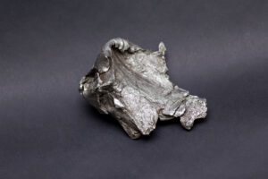 This two-inch fragment of the Sikhote-Alin iron meteorite was shaped by violent impact with the Earth.