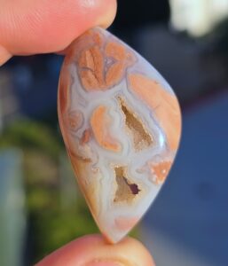Youngite cabbed specimen with druzy pockets.