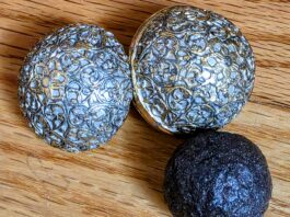 Madstones: The Strange Folk Remedy for Rabies Enterolith, alongside a copy of a 17th-century India (Mughal Period) round pill box adapted from a silver case, cast in lead-free pewter, electroplated with 24-carat gold and coated with a silver lacquer to create a two-toned effect.